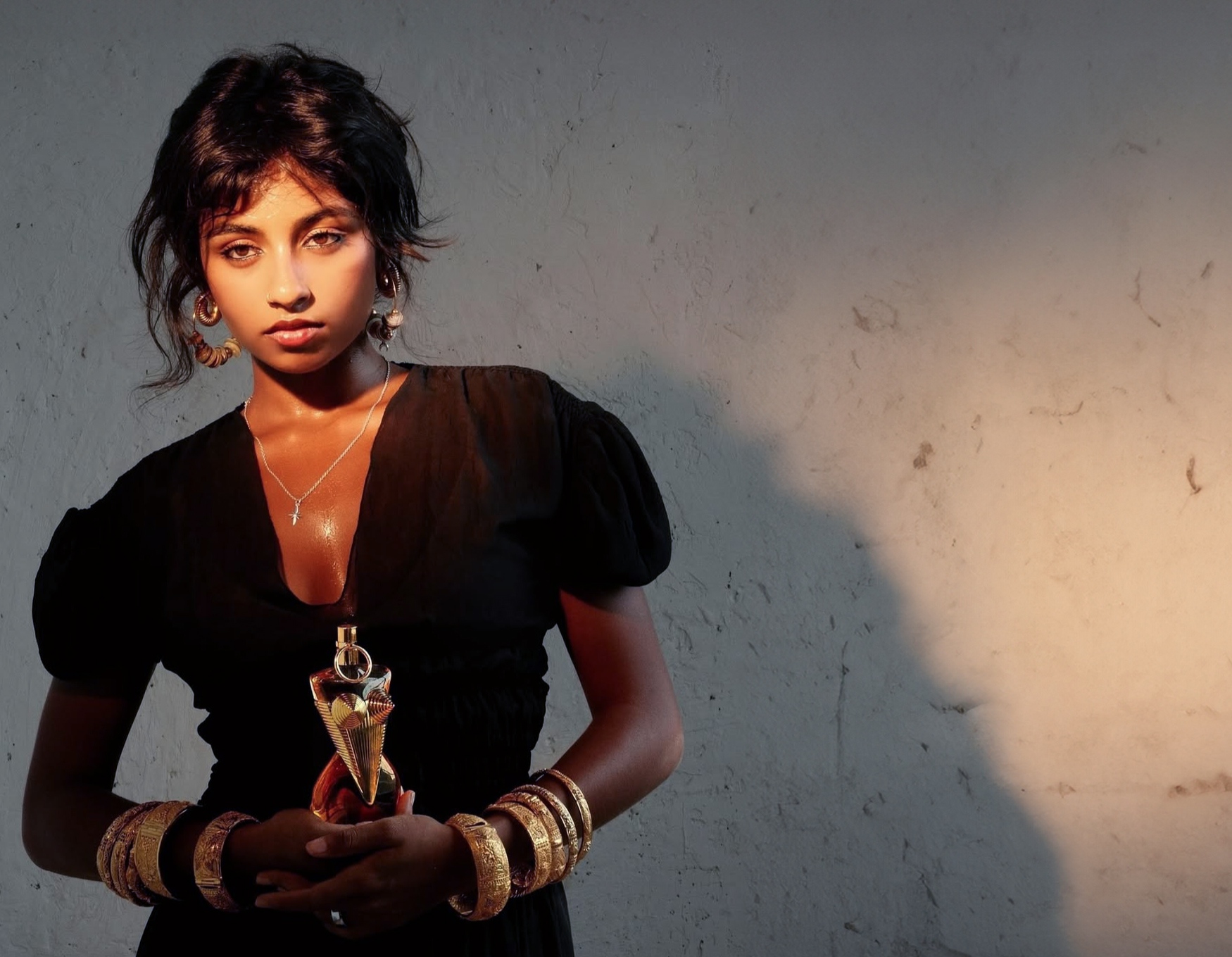 A picture of Tanya Ravichandran holding a bottle of Jean Paul Gaultier.